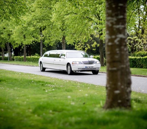 white-limousine-driving-on-road-2504936-scaled.jpg